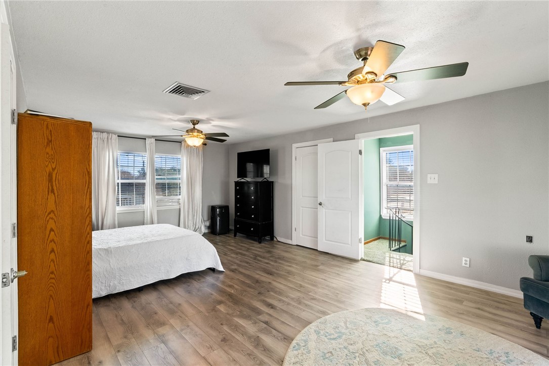 302 Cole Street Corpus Christi, TX 78404 - Photo 24 of 40 a bedroom with a bed and wooden floor