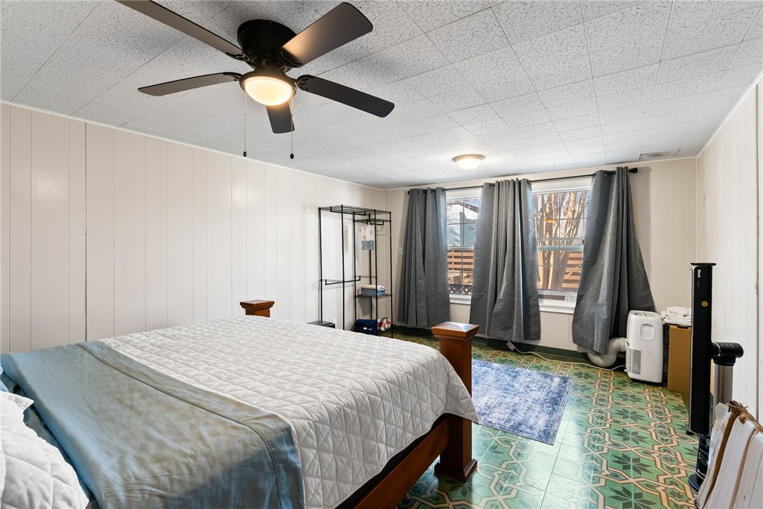 302 Cole Street Corpus Christi, TX 78404 - Photo 28 of 40 a bedroom with a large bed and a chandelier