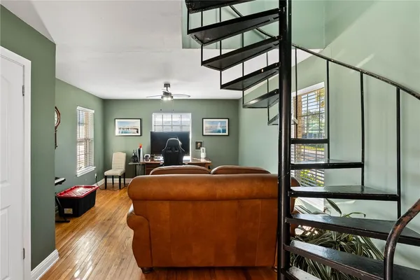 a room with wooden floor and furniture
