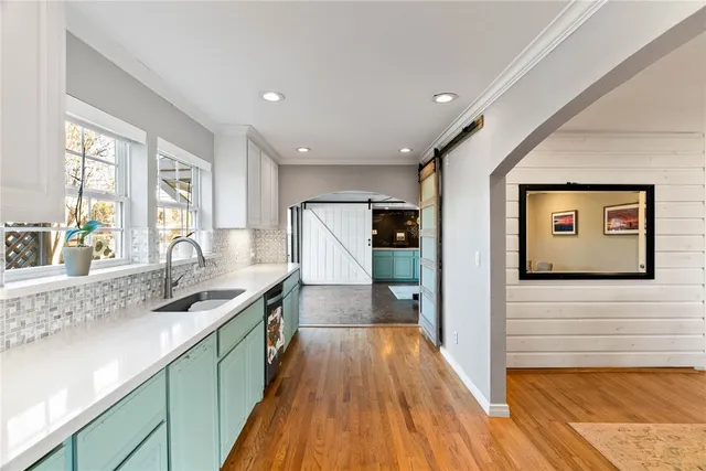 a kitchen with stainless steel appliances granite countertop a sink stove and wooden floor