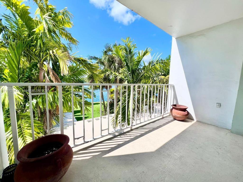 a balcony with table and chairs