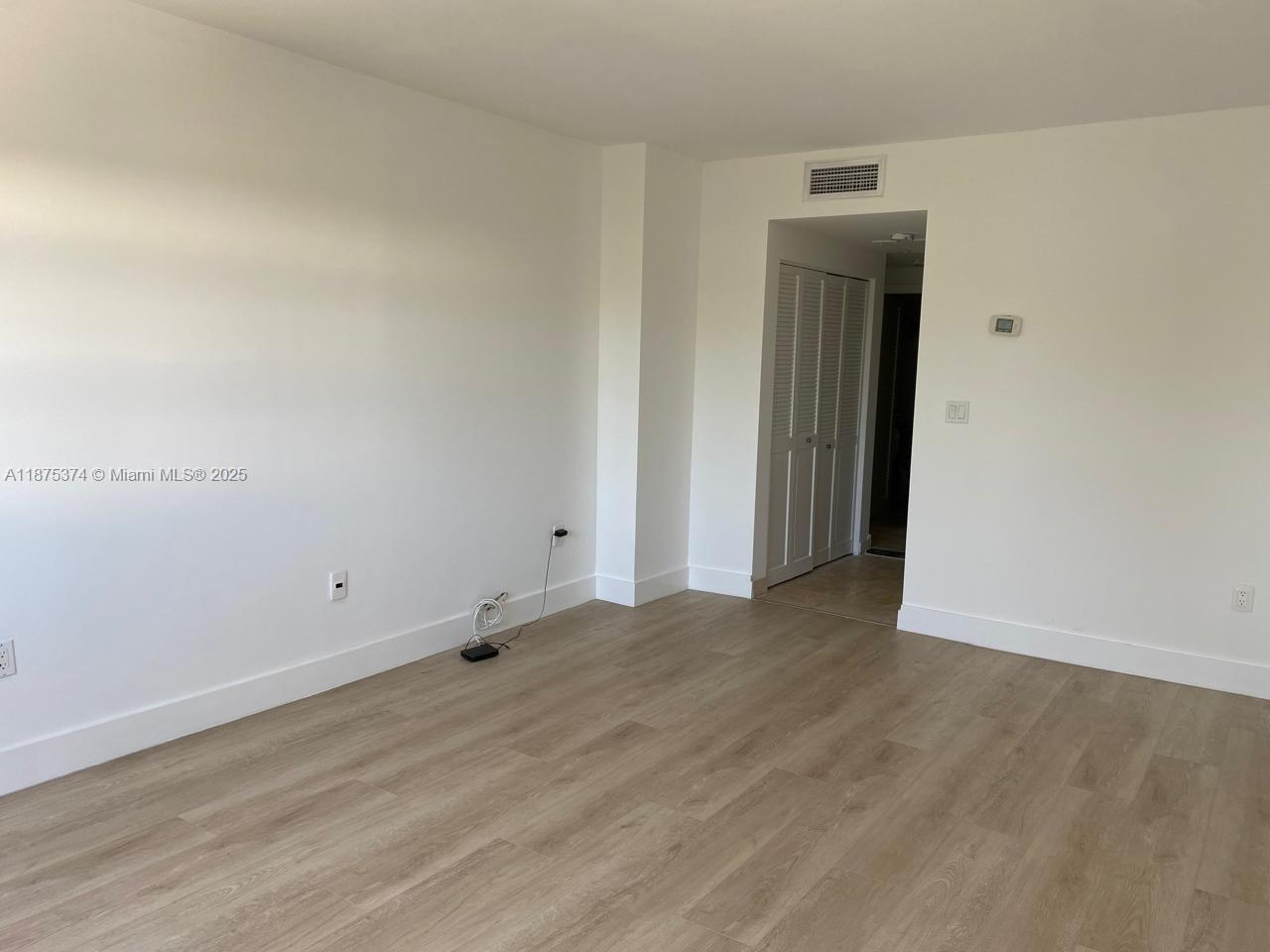 500 Bayview Drive, Unit 230 Sunny Isles Beach, FL 33160 - Photo 17 of 48 an empty room with wooden floor and closet