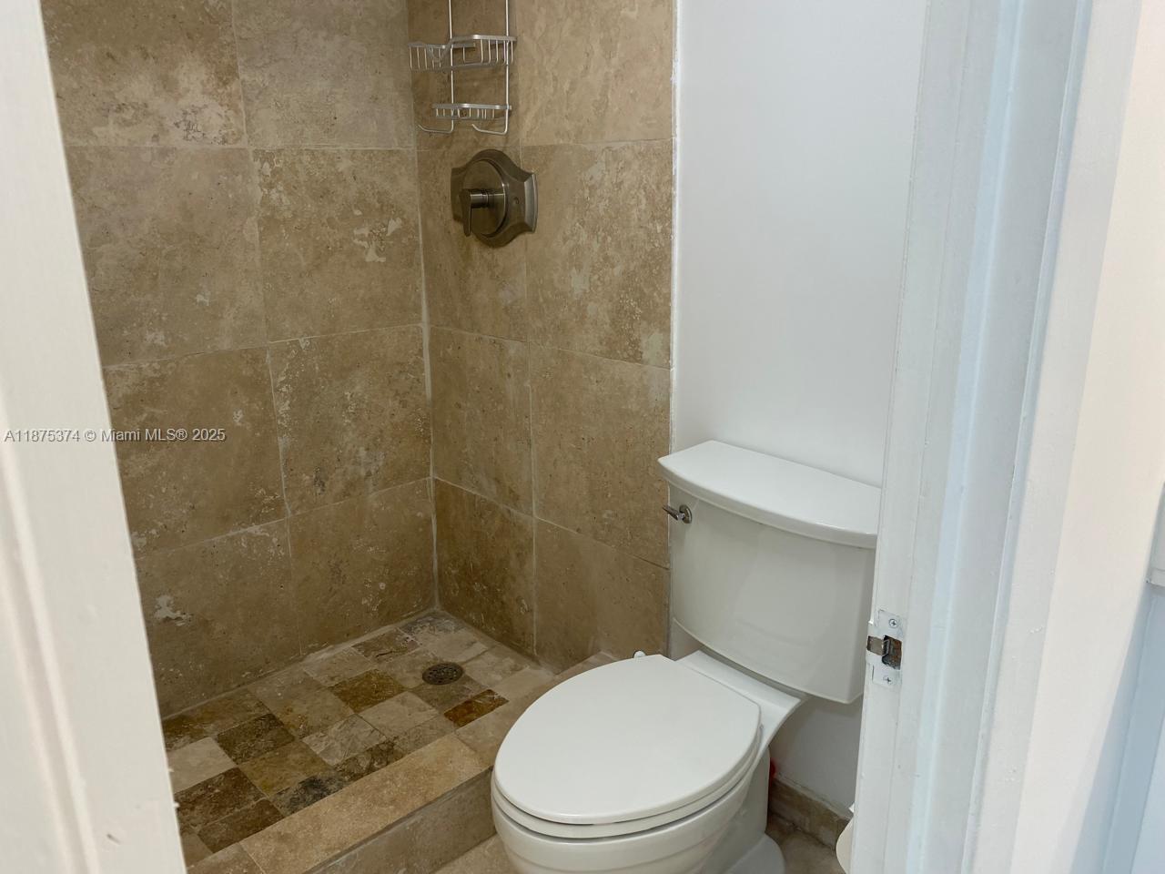 500 Bayview Drive, Unit 230 Sunny Isles Beach, FL 33160 - Photo 24 of 48 a white toilet sitting next to a bathroom