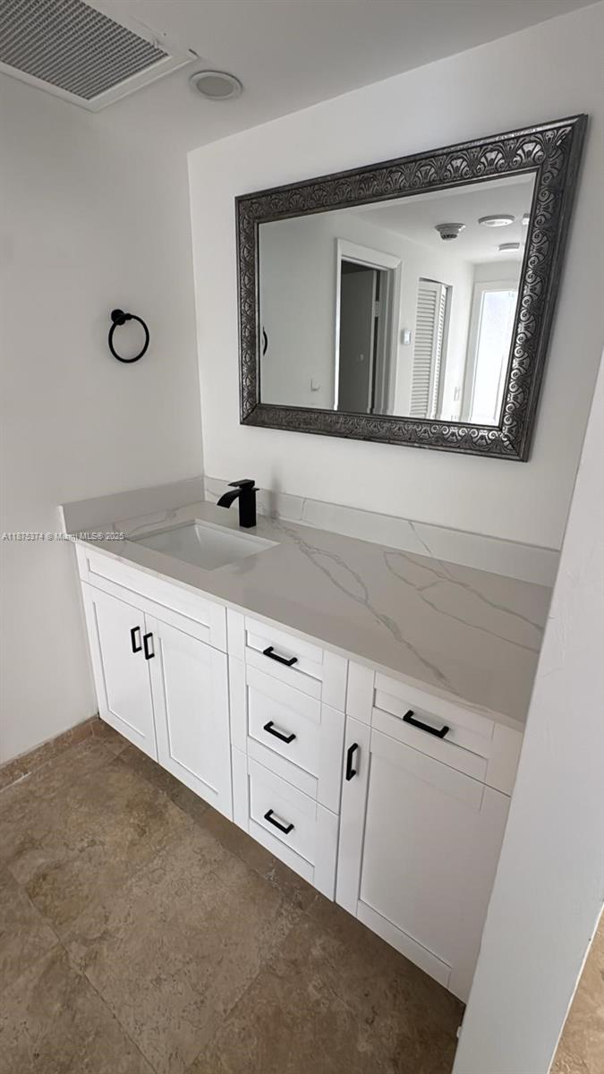 500 Bayview Drive, Unit 230 Sunny Isles Beach, FL 33160 - Photo 27 of 48 a bathroom with a granite countertop sink mirror and vanity