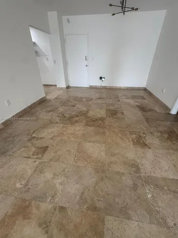 wooden floor in an empty room with a large window