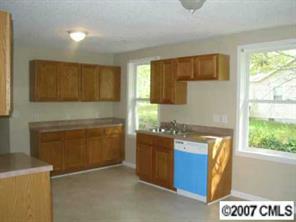 605 Morningside Road Charlotte, NC 28214 - Photo 6 of 8 a kitchen with a refrigerator and a stove