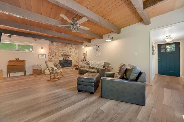 a balcony with wooden floor table and chairs