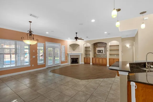 a view of an empty room and window with fireplace