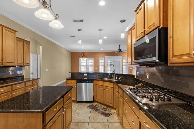 a kitchen with a sink stove and microwave