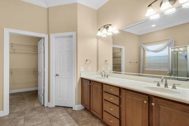 a bathroom with a double vanity sink and a mirror