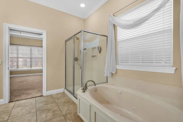 a bathroom with a bathtub and a shower