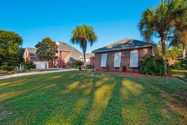 a view of a house with a yard patio and swimming pool