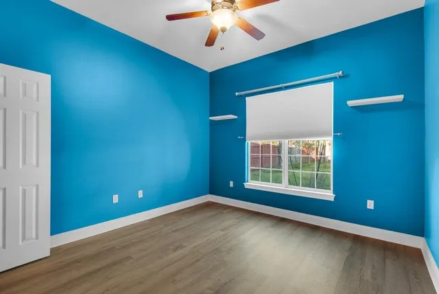 an empty room with windows and closet