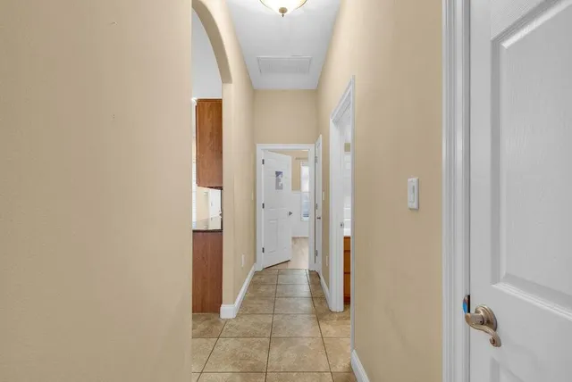 a view of a hallway with wooden shelves