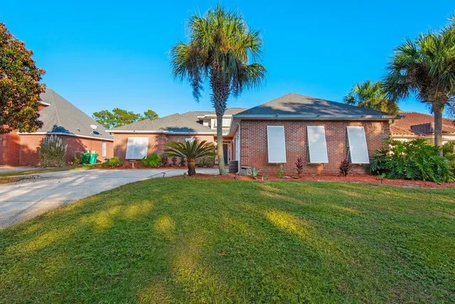 a view of a house with a backyard