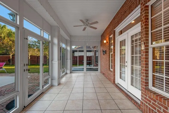 a view of a porch with a table and chairs