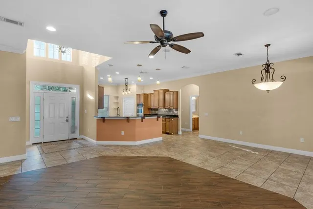 a view of a kitchen with a sink hardwood floor and a ceiling fan