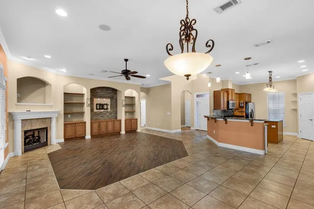 a view of a kitchen with a sink and a fireplace