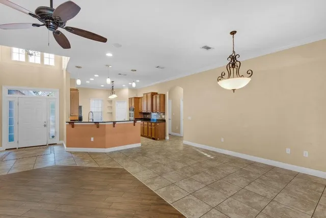 a large kitchen with stainless steel appliances granite countertop a sink a refrigerator and a stove