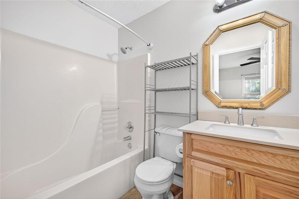 255 Lowry Street Ball Ground, GA 30107 - Photo 11 of 29 a bathroom with a sink a toilet and shower