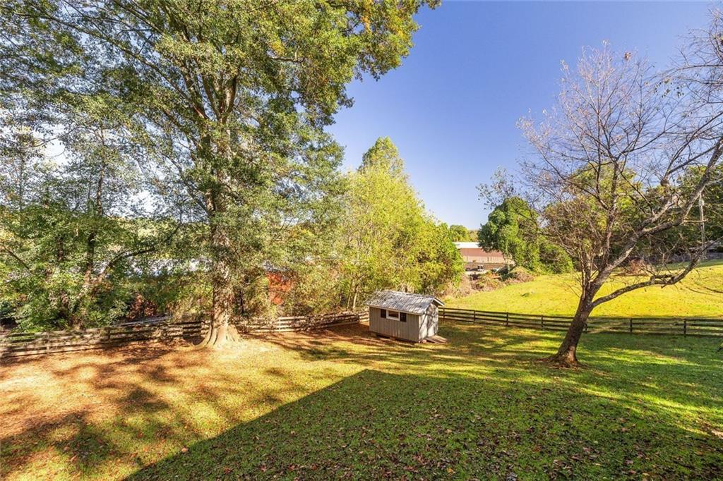 255 Lowry Street Ball Ground, GA 30107 - Photo 17 of 29 a view of a yard with an outdoor space