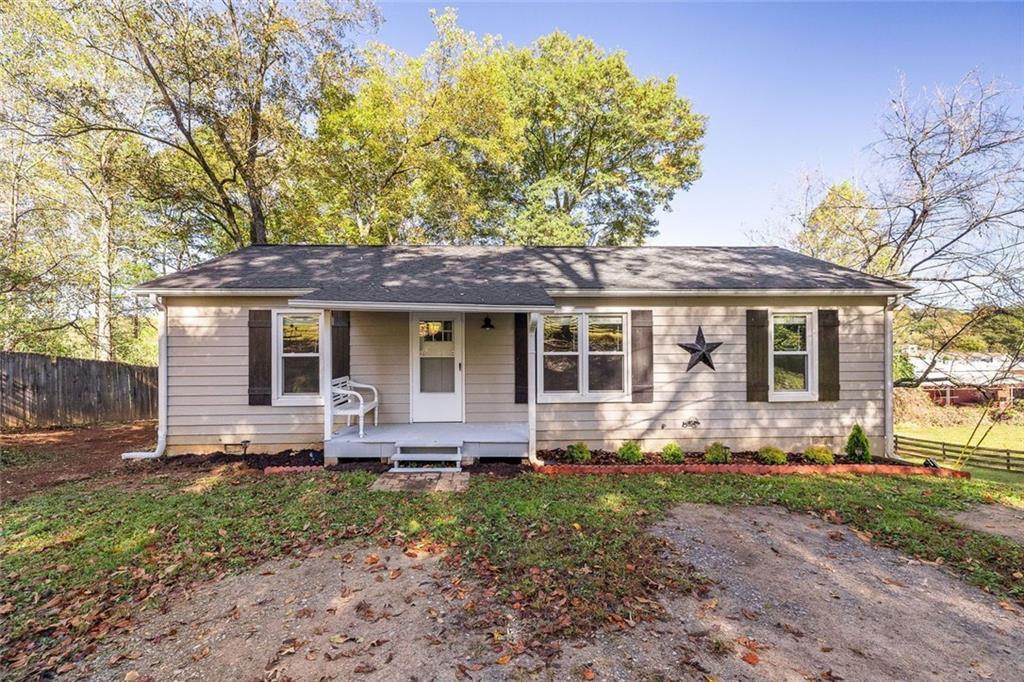 255 Lowry Street Ball Ground, GA 30107 - Photo 20 of 29 front view of a house with a yard