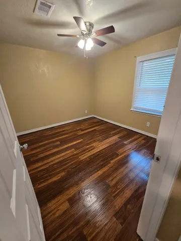 a view of room with wooden floor