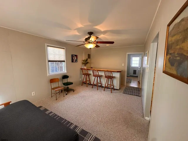 a bedroom with a bed wooden floor and window