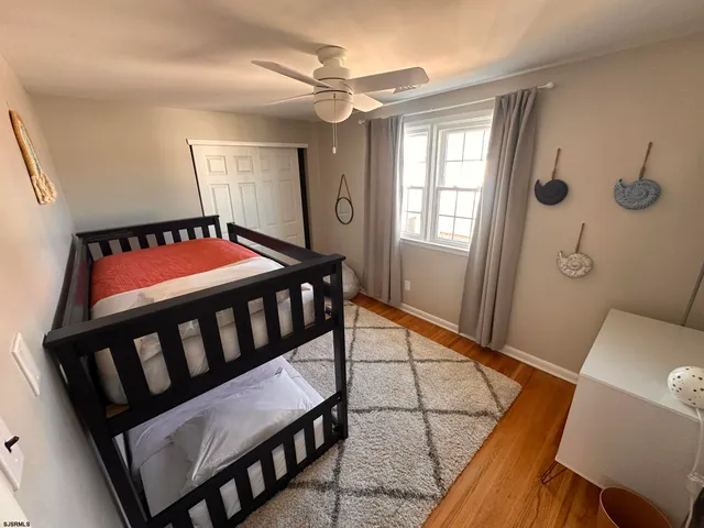 a bathroom with a sink a toilet a mirror and shower