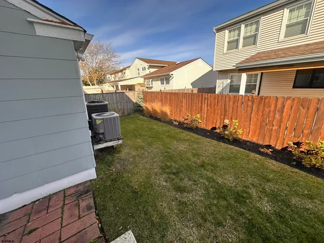 a front view of a house with a garden and trees