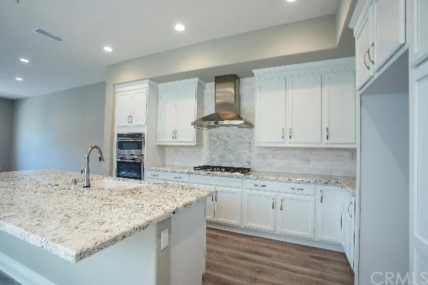 146 Spectacle Irvine, CA 92618 - Photo 14 of 57 a kitchen with stainless steel appliances granite countertop a sink stove and cabinets