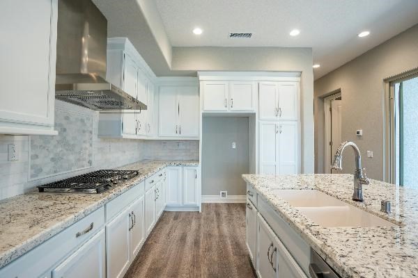 146 Spectacle Irvine, CA 92618 - Photo 17 of 57 a kitchen with granite countertop a sink stove and cabinets
