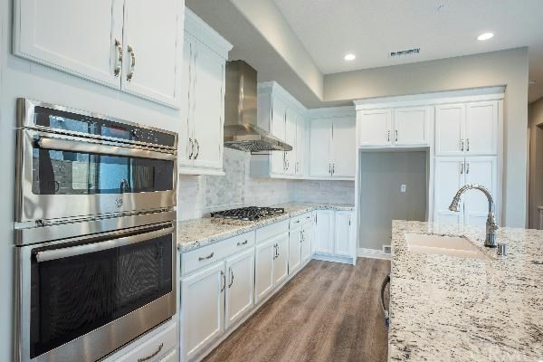 146 Spectacle Irvine, CA 92618 - Photo 18 of 57 a kitchen with stainless steel appliances granite countertop a stove and a sink