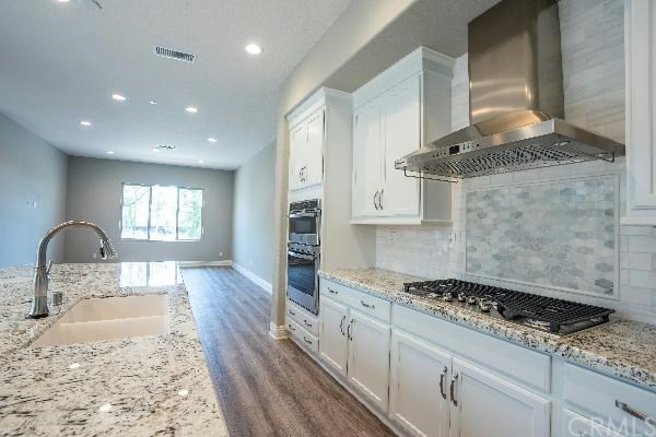 146 Spectacle Irvine, CA 92618 - Photo 21 of 57 a kitchen with granite countertop a stove and a sink