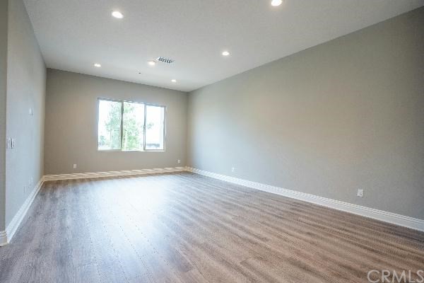 146 Spectacle Irvine, CA 92618 - Photo 24 of 57 a view of an empty room with wooden floor and a window