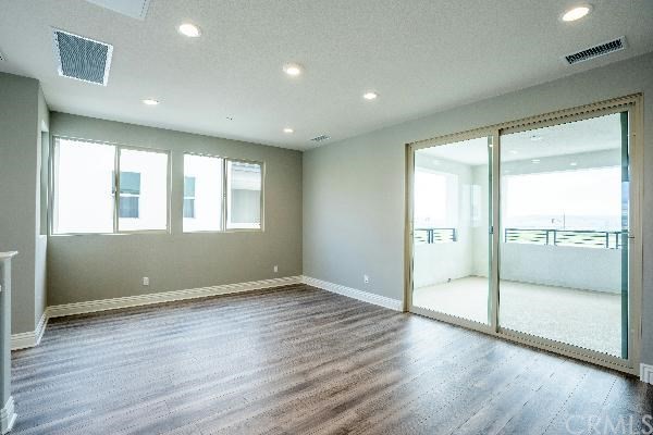 146 Spectacle Irvine, CA 92618 - Photo 26 of 57 a view of an empty room with wooden floor and a window