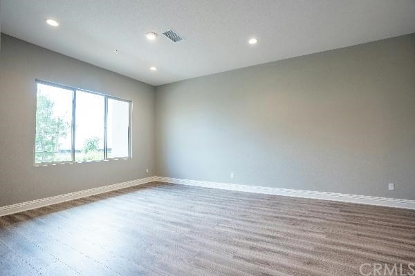 146 Spectacle Irvine, CA 92618 - Photo 27 of 57 an empty room with wooden floor and windows