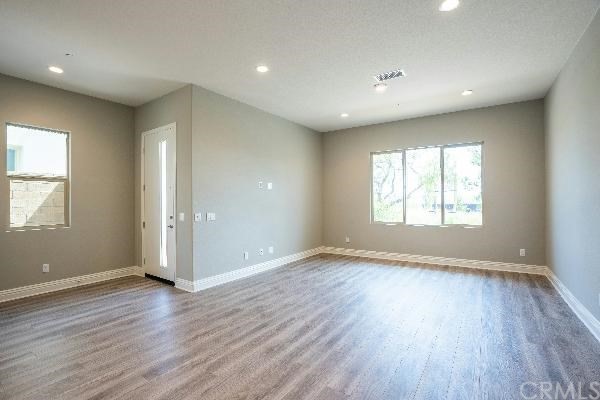 146 Spectacle Irvine, CA 92618 - Photo 30 of 57 an empty room with wooden floor and windows