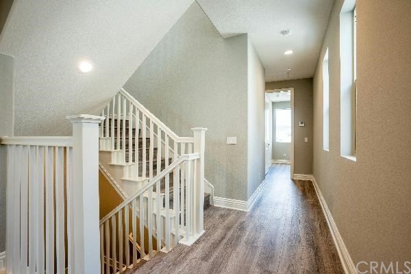 146 Spectacle Irvine, CA 92618 - Photo 35 of 57 a view of a hallway with wooden floor and entryway