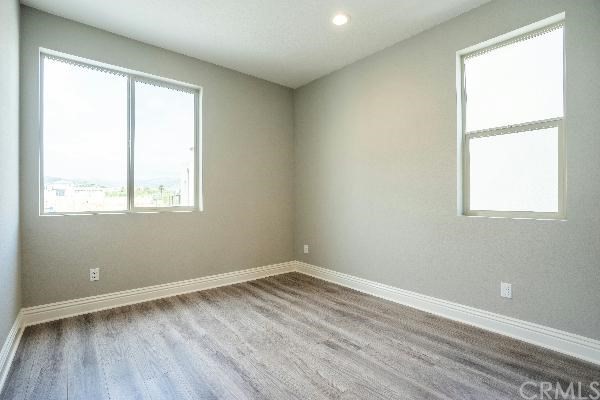 146 Spectacle Irvine, CA 92618 - Photo 37 of 57 an empty room with wooden floor and windows