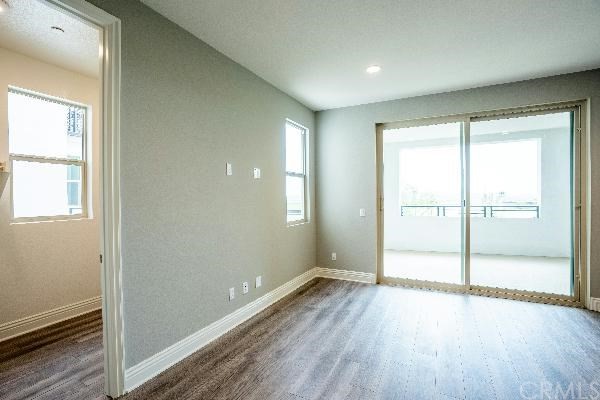 146 Spectacle Irvine, CA 92618 - Photo 40 of 57 an empty room with wooden floor and windows