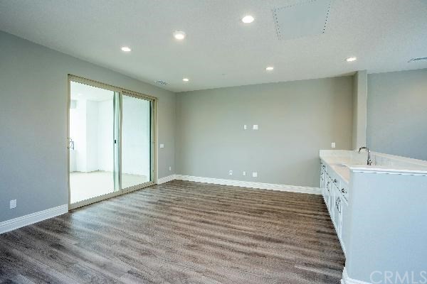 146 Spectacle Irvine, CA 92618 - Photo 42 of 57 a view of an empty room with wooden floor and a window