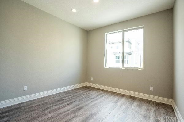 146 Spectacle Irvine, CA 92618 - Photo 45 of 57 wooden floor in an empty room with a window