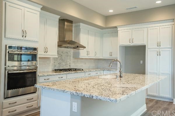 146 Spectacle Irvine, CA 92618 - Photo 8 of 57 a kitchen with stainless steel appliances granite countertop a sink stove and refrigerator