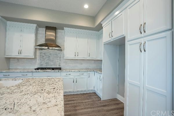 146 Spectacle Irvine, CA 92618 - Photo 10 of 57 a kitchen with granite countertop white cabinets and stainless steel appliances