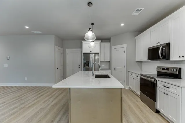 a kitchen with granite countertop a stove and a sink