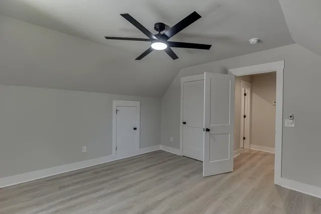 a view of empty room with wooden floor