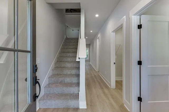 a view of entryway and hall with wooden floor