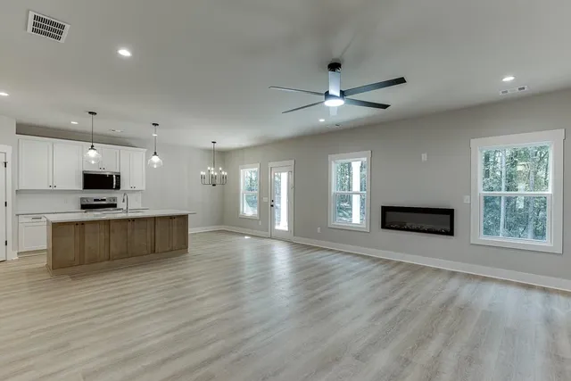 a view of kitchen with microwave and stove top oven