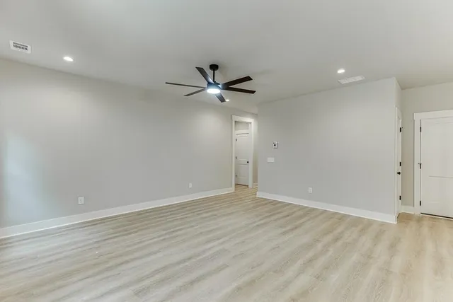 a view of an empty room with a ceiling fan